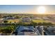 An aerial view of homes with solar panels, backyard pools, horse fields, and a vast landscape under a bright sky at 1925 E La Costa Dr, Gilbert, AZ 85298