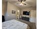 Comfortable bedroom featuring a full-sized bed, dresser, and a flat-screen TV mounted to the wall at 1925 E La Costa Dr, Gilbert, AZ 85298