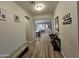 Inviting entryway with wood-look tile flooring and arched doorway leading to an open-concept living space at 1925 E La Costa Dr, Gilbert, AZ 85298