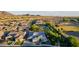 Expansive single-Gathering home featuring a basketball court, well-manicured yard, and solar panels set against a backdrop of scenic mountains at 1925 E La Costa Dr, Gilbert, AZ 85298