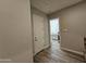 Hallway with wood-look tile flooring, white doors and access to laundry room at 1925 E La Costa Dr, Gilbert, AZ 85298