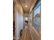 Hallway features wood-look tile flooring and natural light from window at 1925 E La Costa Dr, Gilbert, AZ 85298