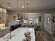 Stylish kitchen with stainless steel pendant lights overlooking the dining area and quartz countertops at 1925 E La Costa Dr, Gilbert, AZ 85298