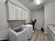 Bright laundry room featuring a new washer, dryer, and lots of cabinet space at 1925 E La Costa Dr, Gilbert, AZ 85298