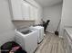 Bright laundry room with white cabinetry, washer and dryer at 1925 E La Costa Dr, Gilbert, AZ 85298