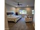 Comfortable main bedroom featuring a ceiling fan, sitting area, and natural light from multiple windows at 1925 E La Costa Dr, Gilbert, AZ 85298