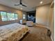 Spacious carpeted main bedroom with sitting area, ceiling fan, and flat-screen TV above a gray console at 1925 E La Costa Dr, Gilbert, AZ 85298