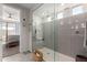 Bright bathroom featuring a glass shower with gray tiling and seamless access to bedroom at 19919 W Harrison St, Buckeye, AZ 85326