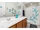 Well-lit bathroom with white countertops, wood cabinets, and tasteful nautical decor at 19919 W Harrison St, Buckeye, AZ 85326