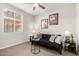 Bedroom features a futon, ceiling fan and natural light at 19919 W Harrison St, Buckeye, AZ 85326