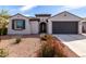 Charming single-story home featuring a well-manicured landscape, inviting entrance, and attached two-car garage at 19919 W Harrison St, Buckeye, AZ 85326