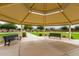 Community gazebo with shaded seating area and a view of the green space at 19919 W Harrison St, Buckeye, AZ 85326