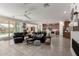 Bright and spacious living room features cozy seating, a ceiling fan, and seamless transition to the kitchen at 19919 W Harrison St, Buckeye, AZ 85326