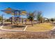 Playground area with multiple play structures and seating at 19919 W Harrison St, Buckeye, AZ 85326