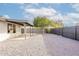 A backyard with a gravel yard, a covered patio, and a tree at 2016 N Pennington Dr, Chandler, AZ 85224