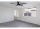 Bright bedroom features a ceiling fan, a window, and plush gray carpet at 2016 N Pennington Dr, Chandler, AZ 85224