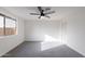 Bright bedroom features a ceiling fan, a window, and plush gray carpet at 2016 N Pennington Dr, Chandler, AZ 85224