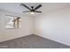 Bright bedroom features a ceiling fan, a window, and plush gray carpet at 2016 N Pennington Dr, Chandler, AZ 85224