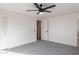 Bright bedroom features a ceiling fan, closet doors, and plush gray carpet at 2016 N Pennington Dr, Chandler, AZ 85224