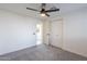 Bright bedroom features a ceiling fan, closet doors, and plush gray carpet at 2016 N Pennington Dr, Chandler, AZ 85224