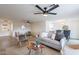 A spacious living room featuring modern decor, ceiling fan, and wood look flooring at 2016 N Pennington Dr, Chandler, AZ 85224