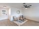 Bright seating area featuring updated decor, ceiling fan, and modern flooring at 2016 N Pennington Dr, Chandler, AZ 85224