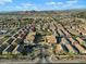 Expansive aerial view of a neighborhood featuring well-maintained homes, desert landscape, and picturesque mountain views at 2150 E Bell Rd # 1134, Phoenix, AZ 85022