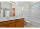 Bathroom featuring a double sink vanity, with tile flooring, a soaking tub and an enclosed toilet at 2150 E Bell Rd # 1134, Phoenix, AZ 85022