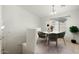 Bright dining area features modern chandelier, round table, and lovely natural light from the adjacent window at 2150 E Bell Rd # 1134, Phoenix, AZ 85022