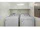 A laundry room equipped with washer, dryer and convenient shelving at 2150 E Bell Rd # 1134, Phoenix, AZ 85022