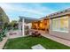 Inviting backyard featuring an ample patio with a pergola, lush landscaping, and artificial grass at 2169 E Alameda Dr, Tempe, AZ 85282