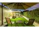 Backyard lounge area featuring patio umbrella with green artificial turf at 2169 E Alameda Dr, Tempe, AZ 85282