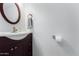 Well lit half bath with a wood vanity and a white sink at 2169 E Alameda Dr, Tempe, AZ 85282