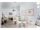 Bright dining area with a glass table and chairs, seamlessly connected to the living room, ideal for entertaining guests at 2169 E Alameda Dr, Tempe, AZ 85282