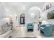 Inviting foyer with arched doorways, tile flooring, and a glimpse of the detailed front door, creating an open and airy entrance at 2169 E Alameda Dr, Tempe, AZ 85282