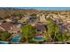 Scenic aerial view of a residential neighborhood with mature trees and a home with a private pool at 2633 E Amber Ridge Way, Phoenix, AZ 85048