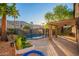 Enjoy outdoor living on the shaded patio, next to the pool with secure fencing and mature landscape at 2633 E Amber Ridge Way, Phoenix, AZ 85048