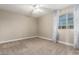 Bedroom with light tan walls, carpet, a ceiling fan, and a single window at 2633 E Amber Ridge Way, Phoenix, AZ 85048