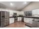 Modern kitchen with stainless steel appliances, granite countertops, and white cabinets at 2633 E Amber Ridge Way, Phoenix, AZ 85048