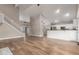 Open living room featuring hardwood floors, a staircase, and a kitchen view at 2633 E Amber Ridge Way, Phoenix, AZ 85048