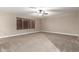 Spacious living room with neutral walls and carpet and a modern ceiling fan at 2633 E Amber Ridge Way, Phoenix, AZ 85048