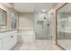 Bright bathroom with double sinks, tub, and glass enclosed shower at 2633 E Amber Ridge Way, Phoenix, AZ 85048