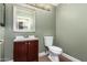 Cozy powder room featuring a vanity, toilet, and framed mirror at 2633 E Amber Ridge Way, Phoenix, AZ 85048