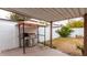 Covered back patio area with a grill and bench space, plus a grassy area with citrus trees at 2744 E Windrose Dr, Phoenix, AZ 85032