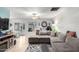 Bright living room featuring a gray sectional sofa, ceiling fan, and natural light at 2744 E Windrose Dr, Phoenix, AZ 85032