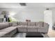 Comfortable living room with a large gray sectional sofa and stylish decor at 2744 E Windrose Dr, Phoenix, AZ 85032