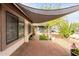 Relaxing covered outdoor patio with brick flooring and desert landscaping at 2744 E Windrose Dr, Phoenix, AZ 85032