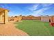 This backyard features a covered patio and low-maintenance landscaping at 3127 W Apollo Rd, Phoenix, AZ 85041