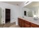 Bright bathroom featuring double sinks, vanity with wood cabinets, and separate shower at 3127 W Apollo Rd, Phoenix, AZ 85041