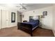 Bedroom showcasing plush carpet, ceiling fan, and natural light at 3127 W Apollo Rd, Phoenix, AZ 85041